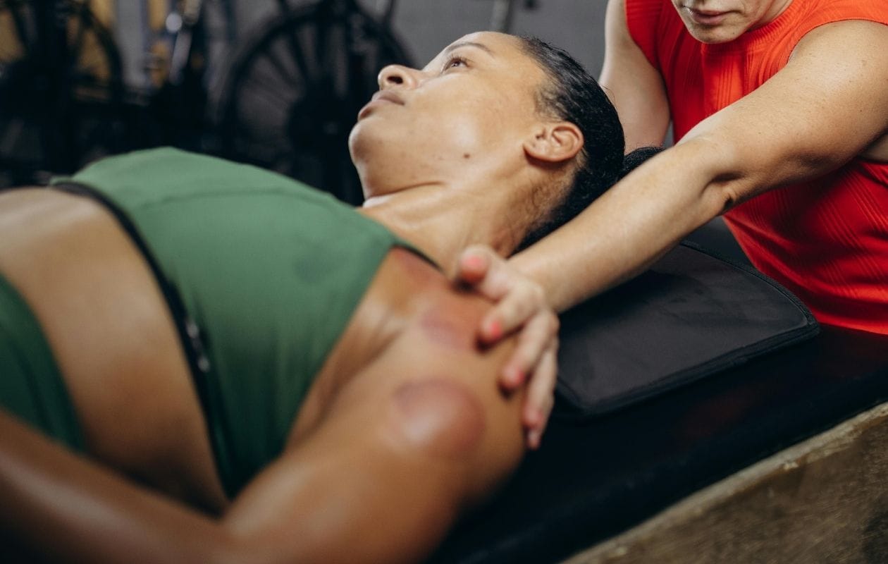 A female lay down receiving a massage