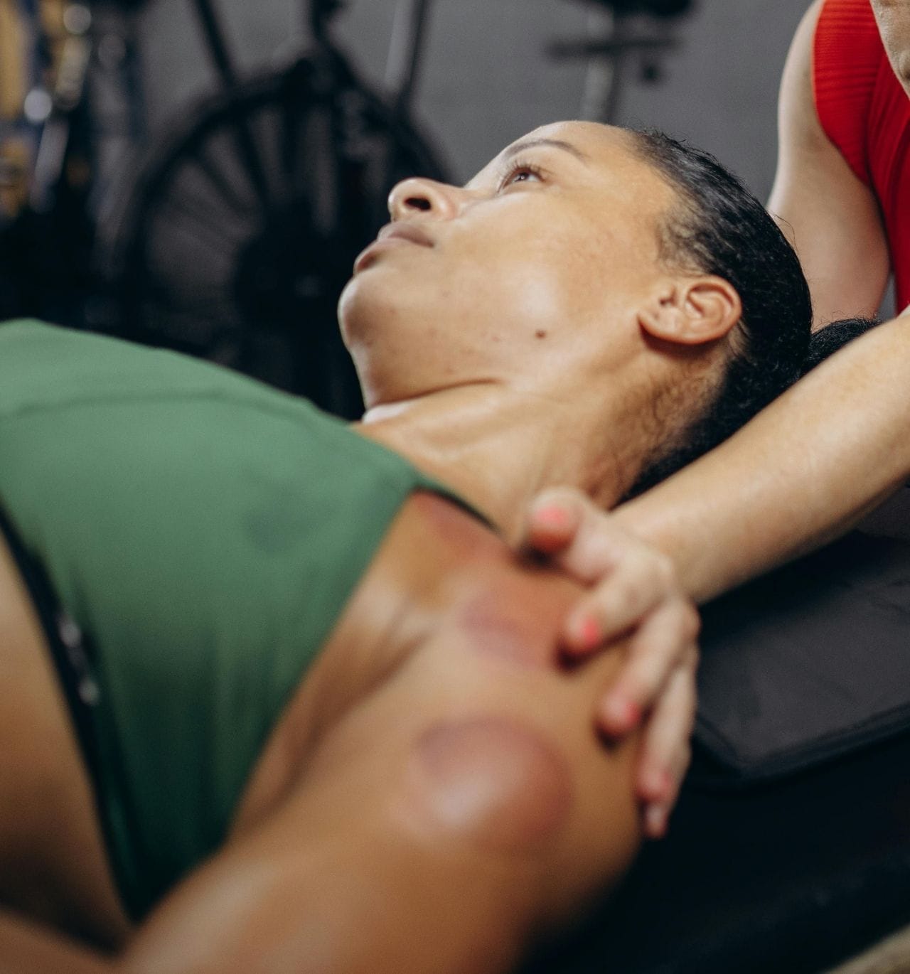 A female lay down receiving a massage