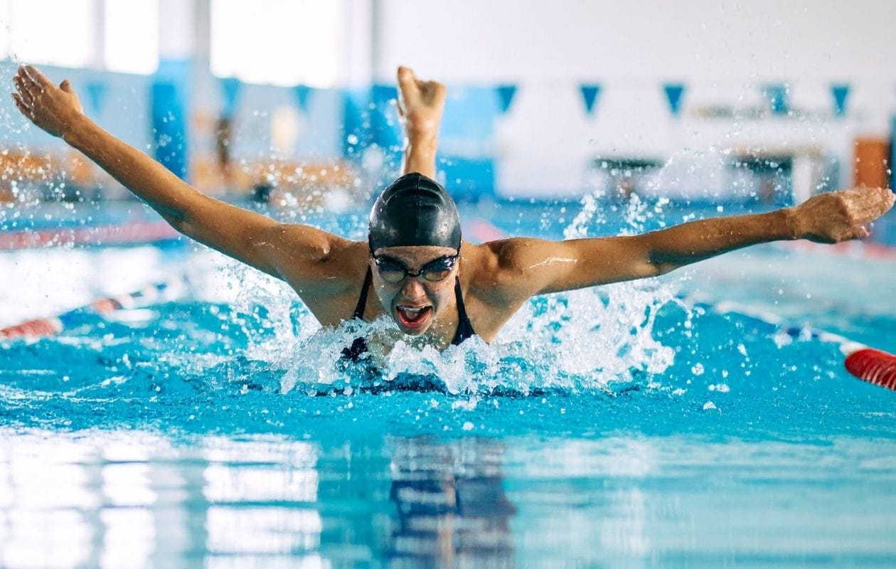 A person swimming the length of a pool