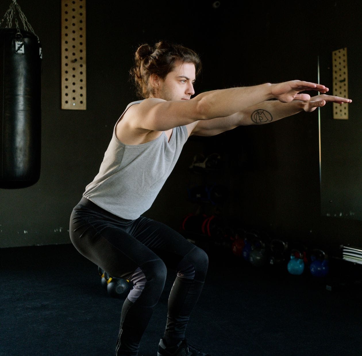 A person squatting in the gym