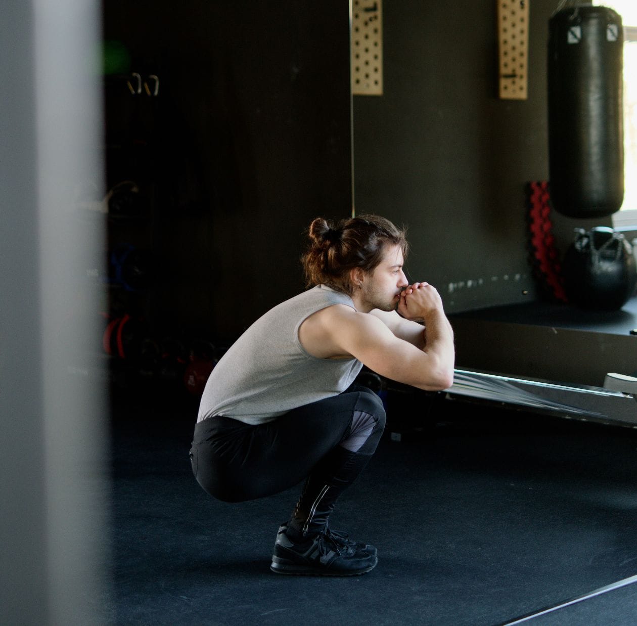 A person squatting in the gym
