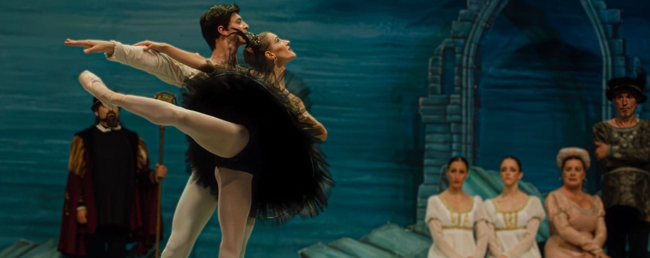 two dancers performing on stage after completing their dance physiotherapy