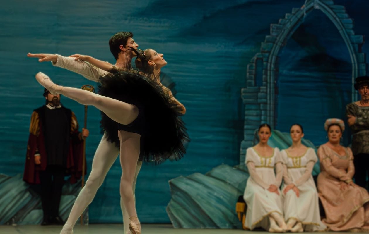 two dancers performing on stage after completing their dance physiotherapy