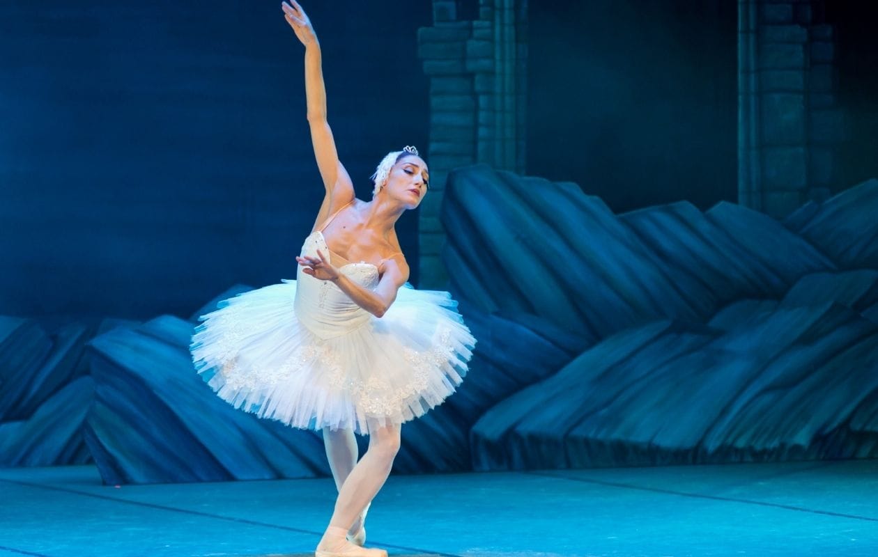 Ballerina standing on stage after performing ballet injury recovery exercises