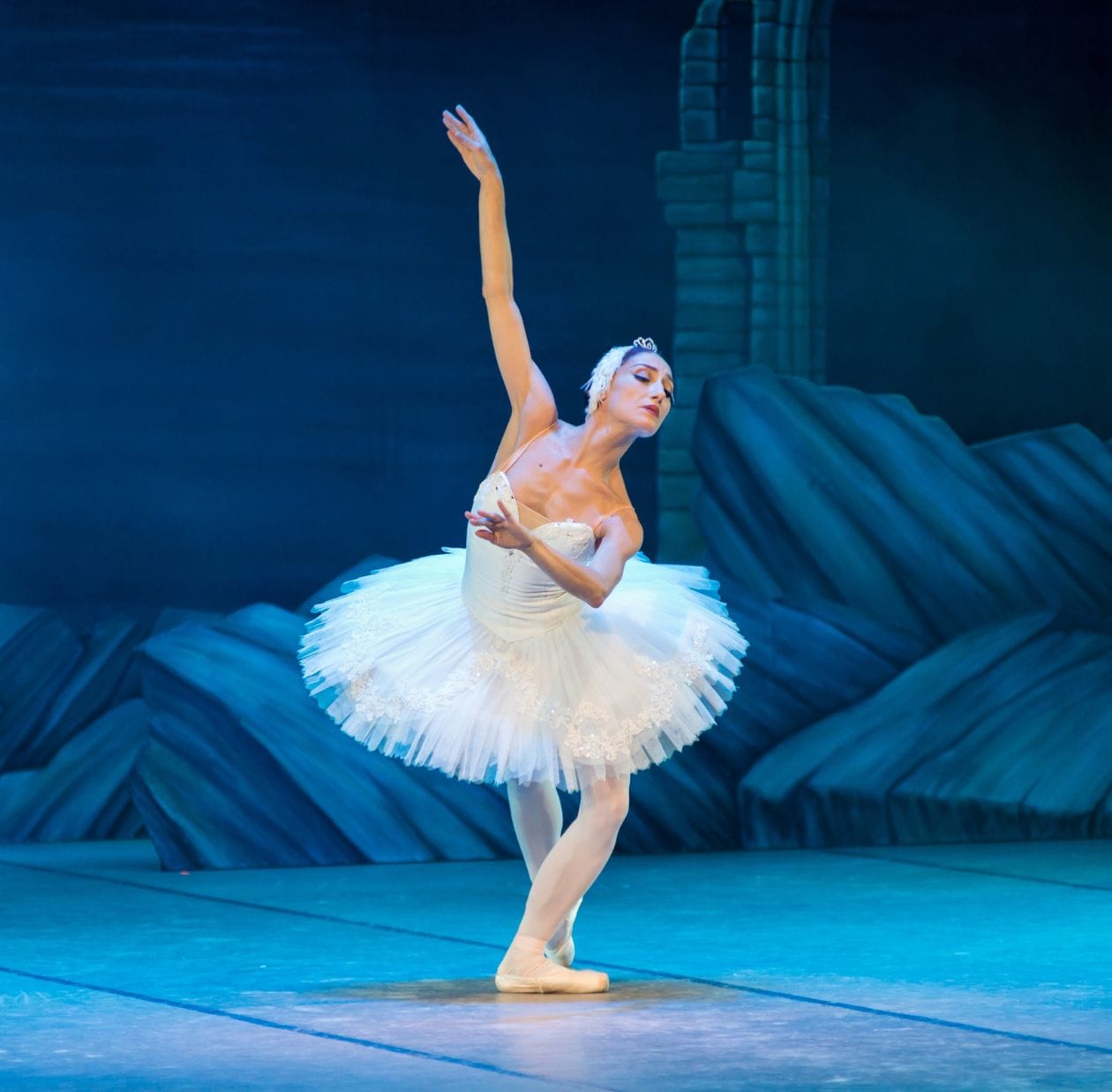 Ballerina standing on stage after performing ballet injury recovery exercises