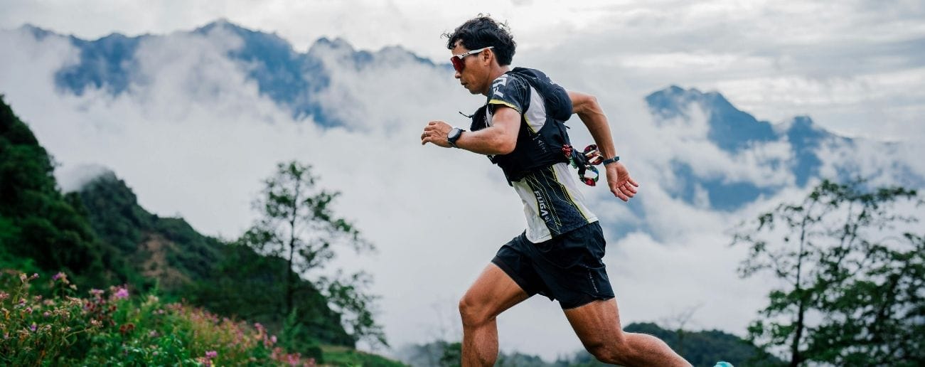 Trail runner training in mountains, supported by running injury rehabilitation in Manchester