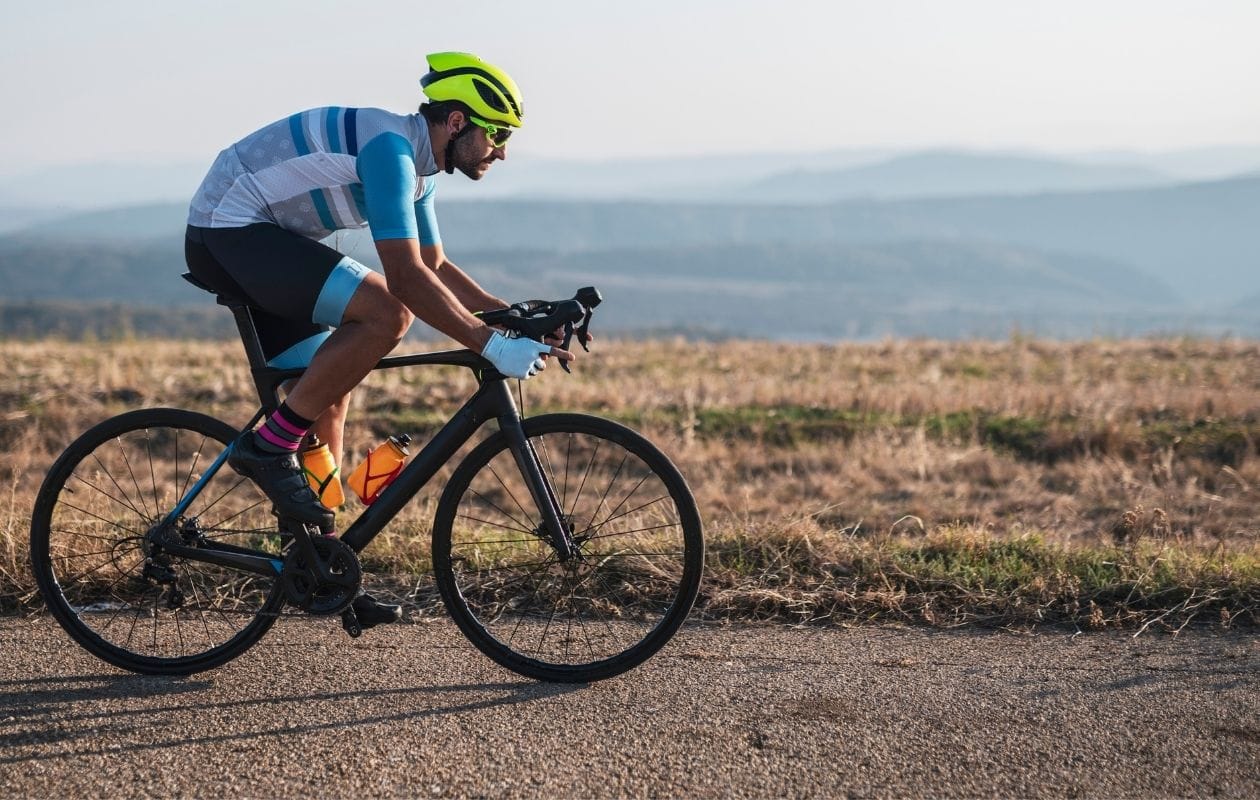 Road cyclist training in countryside, supported by cycling injury rehabilitation in Manchester