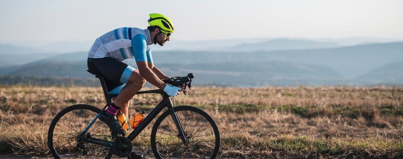 Road cyclist training in countryside, supported by cycling injury rehabilitation in Manchester