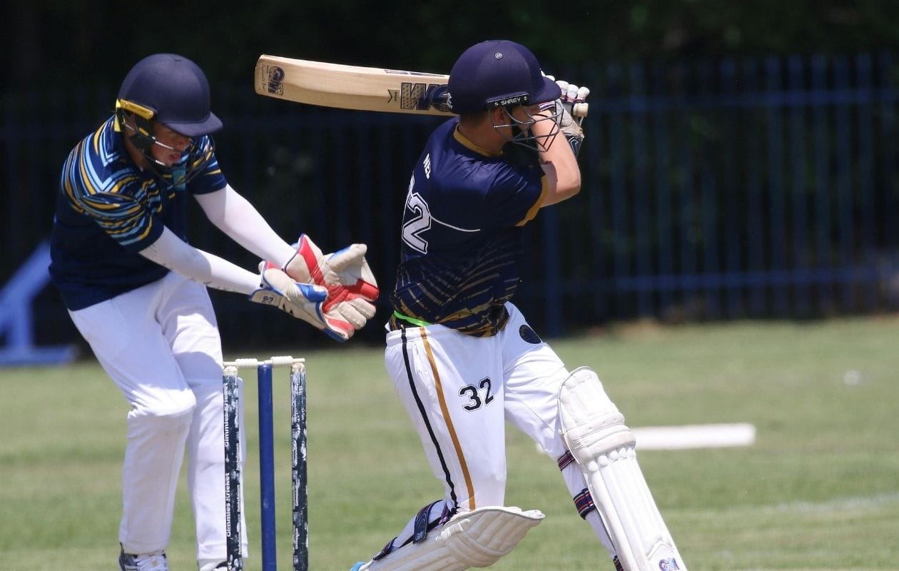 Cricket batsman playing a forward defensive shot, demonstrating the rotational and extension loading common in sports spine injuries