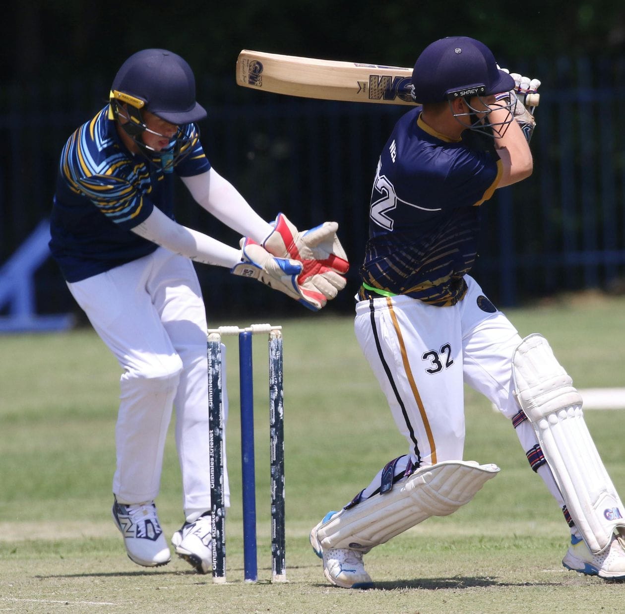 Cricket batsman playing a forward defensive shot, demonstrating the rotational and extension loading common in sports spine injuries